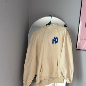 Trendy Cream Hoodie with Blue Logo